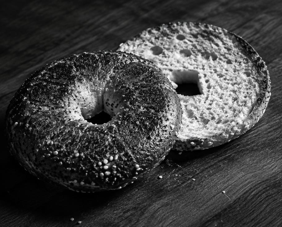 Sliced bagel on a wood counter